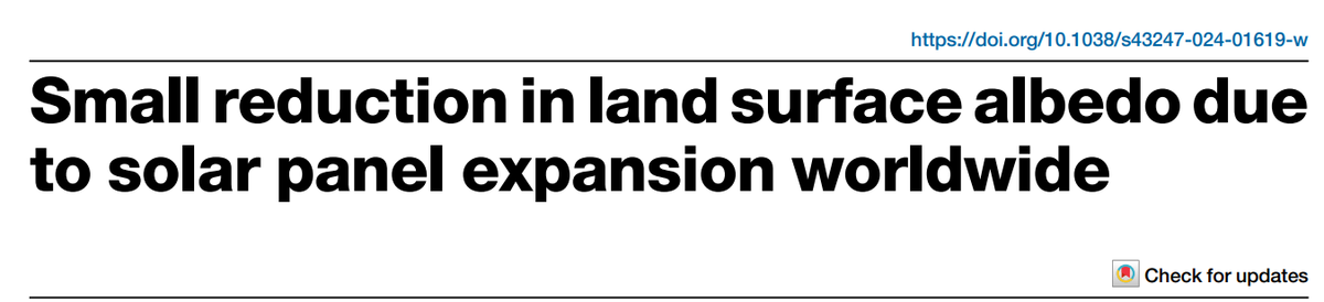Small reduction in land surface albedo due to solar panel expansion worldwide